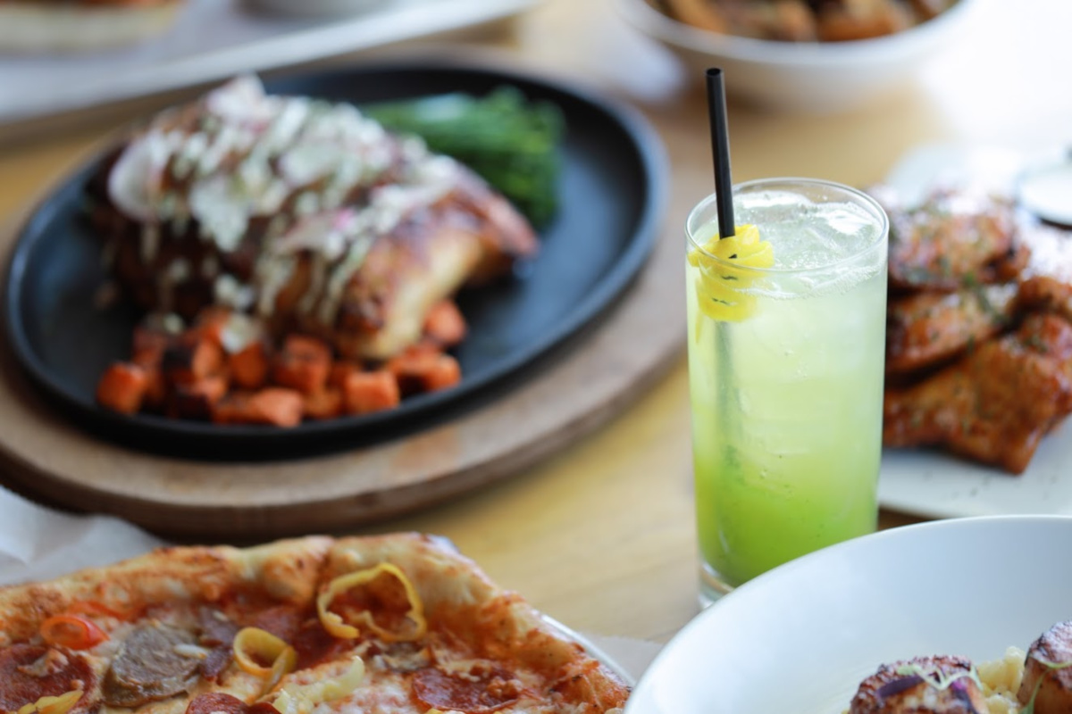 Various dishes and glass of lemonade, closeup